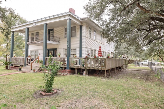 2350 Pecos Blvd, Beaumont, TX 77702 - rear view of house featuring a balcony, a chimney, and a deck