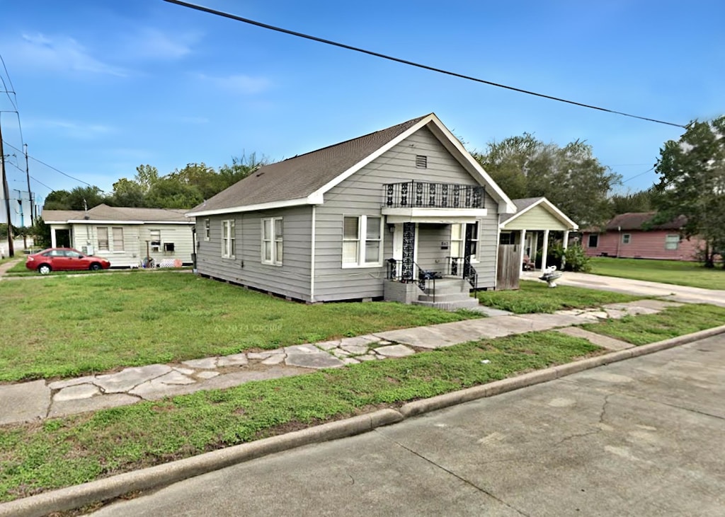 bungalow-style home featuring a front yard