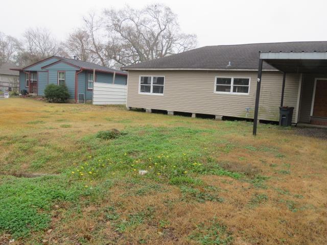 back of property with a yard