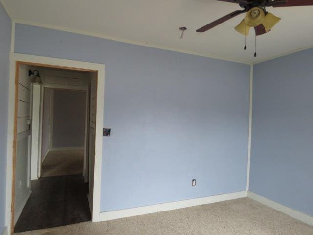 spare room featuring ceiling fan and carpet flooring