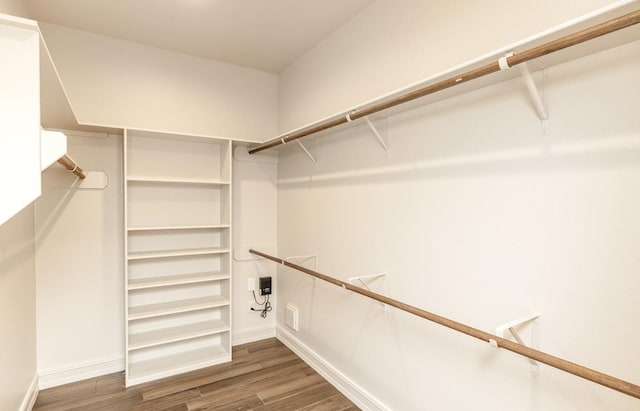 walk in closet featuring dark wood-type flooring