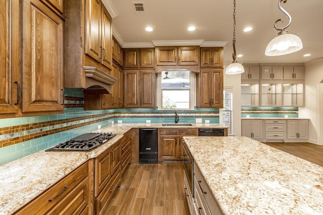 kitchen featuring pendant lighting, sink, hardwood / wood-style floors, and stainless steel gas stovetop