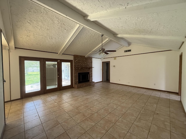 unfurnished living room featuring a textured ceiling, tile patterned flooring, a ceiling fan, lofted ceiling with beams, and a brick fireplace