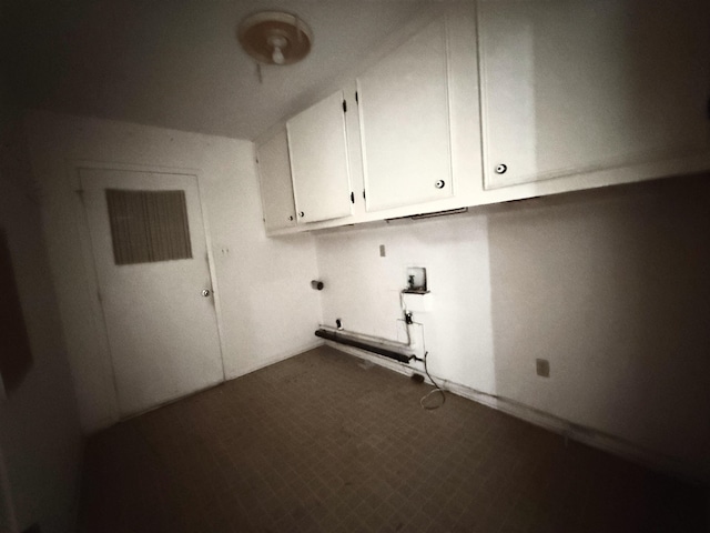 clothes washing area with cabinet space