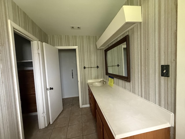 bathroom with wallpapered walls, visible vents, tile patterned floors, and vanity