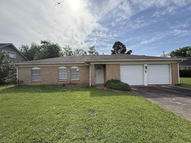 ranch-style home featuring brick siding, a front lawn, a garage, and concrete driveway