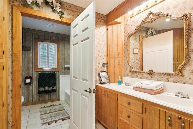 bathroom featuring tile patterned flooring, vanity, and toilet