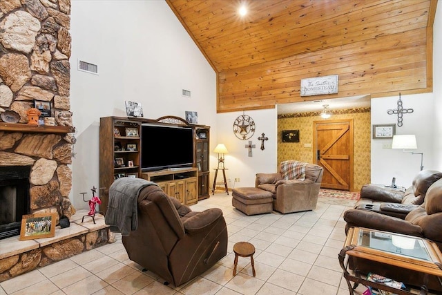 living room featuring wooden ceiling, high vaulted ceiling, a stone fireplace, and light tile patterned flooring