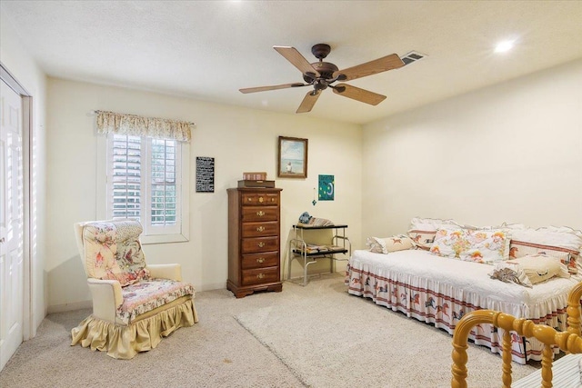 bedroom featuring ceiling fan, a closet, and light carpet