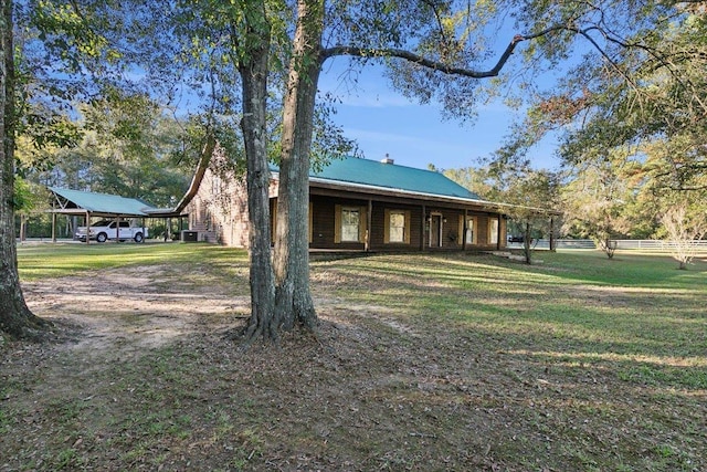 exterior space with a carport and a yard