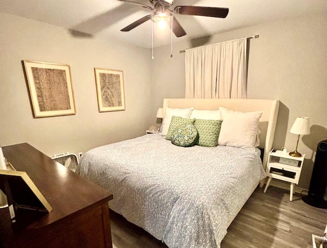 bedroom with ceiling fan and dark hardwood / wood-style floors