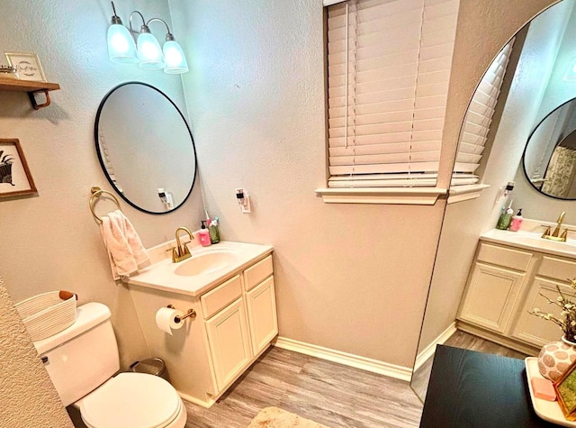 bathroom with hardwood / wood-style floors, vanity, and toilet