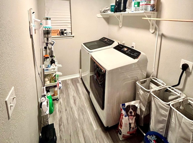 laundry area with hardwood / wood-style floors and washing machine and clothes dryer