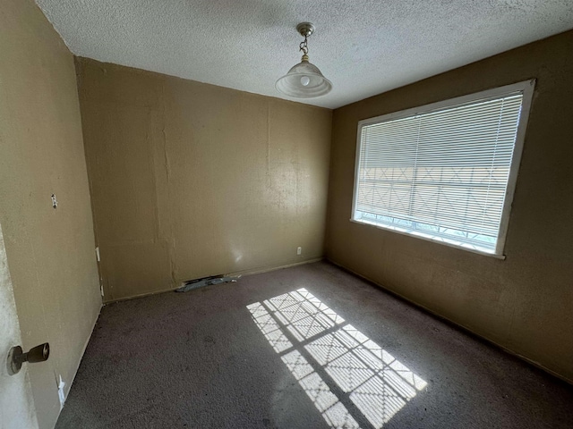 spare room with a textured ceiling