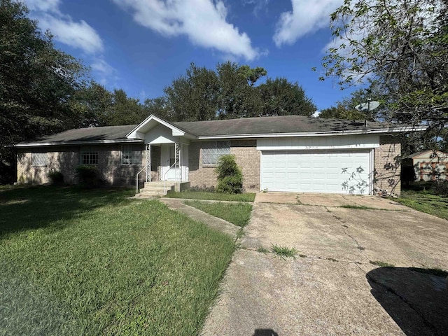 single story home with an attached garage, brick siding, driveway, and a front lawn