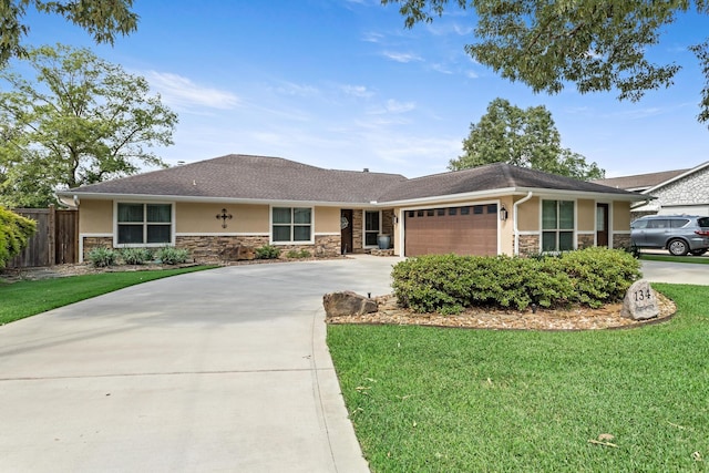 134 Hornbeam, Village Mills, TX 77663 - ranch-style house featuring stone siding, stucco siding, concrete driveway, and a garage