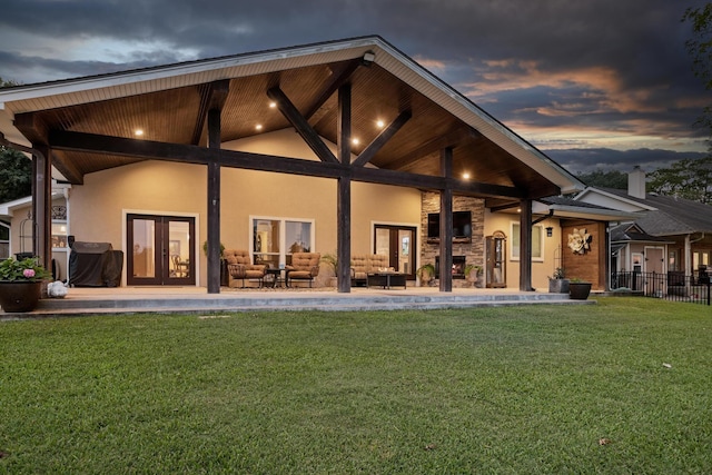 134 Hornbeam, Village Mills, TX 77663 - rear view of house with french doors, an outdoor living space, stucco siding, and stone siding