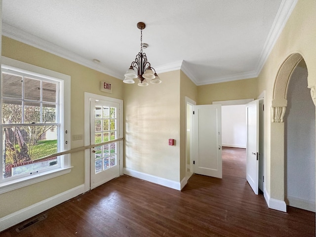 unfurnished dining area with ornamental molding, visible vents, baseboards, and wood finished floors