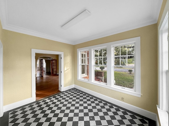 unfurnished sunroom with arched walkways