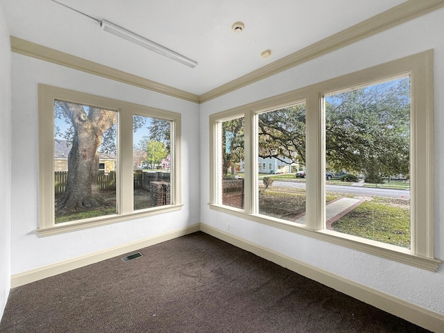 unfurnished sunroom with a healthy amount of sunlight and visible vents