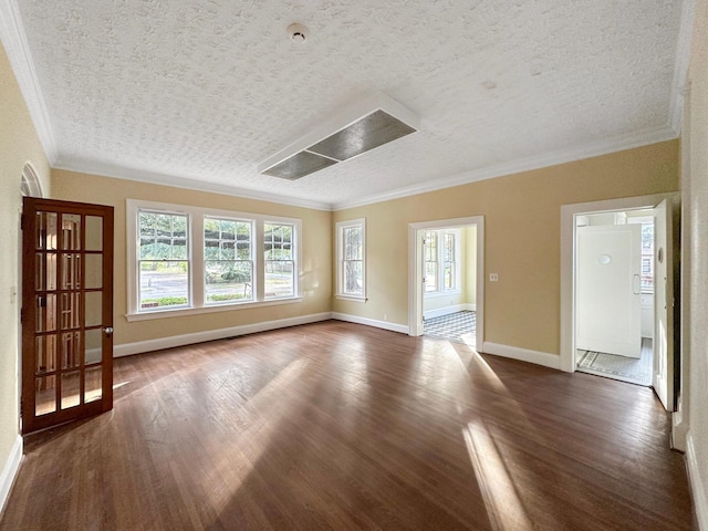 unfurnished room featuring baseboards, ornamental molding, and dark wood finished floors