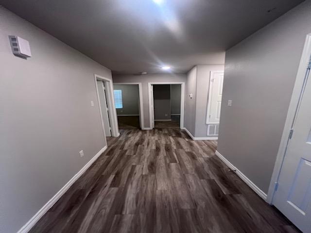 corridor featuring dark hardwood / wood-style floors