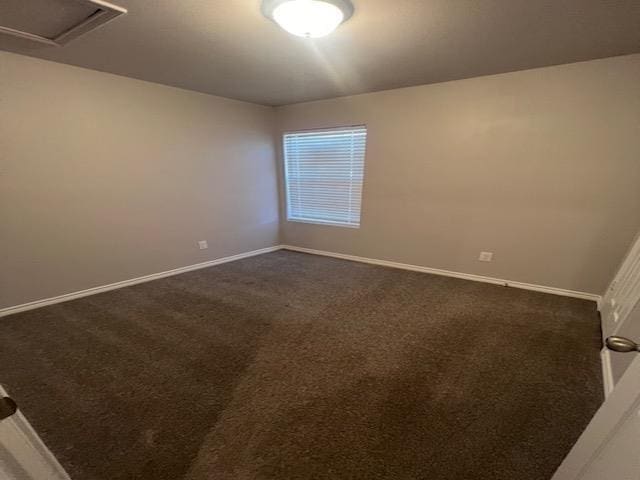 empty room with dark carpet