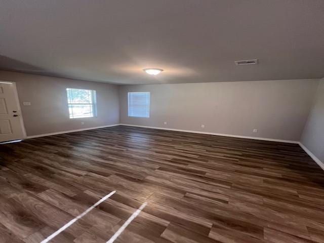 empty room with dark hardwood / wood-style floors