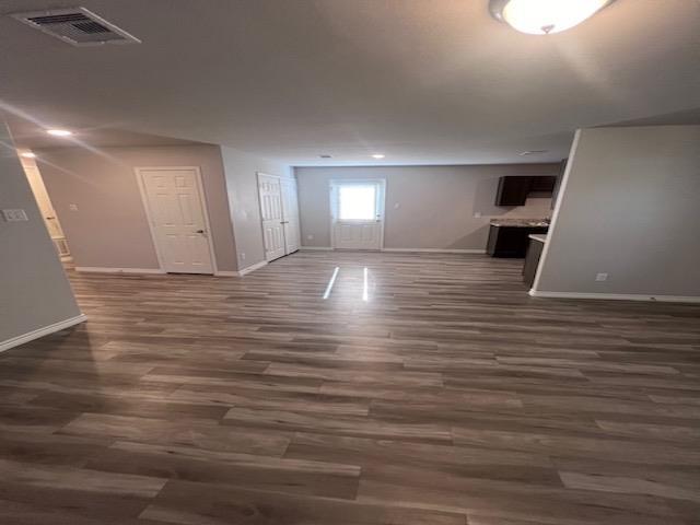 basement with dark hardwood / wood-style flooring