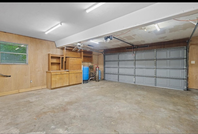 3042 Parish Cemetery Rd, Little Cypress, TX 77632 - garage featuring a garage door opener and wooden walls