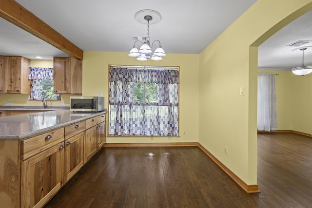 3042 Parish Cemetery Rd, Little Cypress, TX 77632 - kitchen with stainless steel microwave, dark wood-type flooring, arched walkways, pendant lighting, and a chandelier