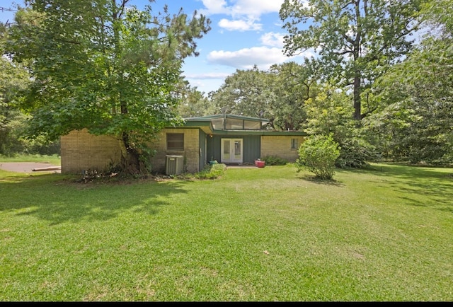 3042 Parish Cemetery Rd, Little Cypress, TX 77632 - view of green lawn with french doors