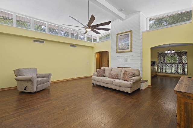 3042 Parish Cemetery Rd, Little Cypress, TX 77632 - living area with arched walkways, a chandelier, a high ceiling, beam ceiling, and dark wood finished floors