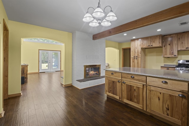 3042 Parish Cemetery Rd, Little Cypress, TX 77632 - kitchen featuring stainless steel range, a chandelier, a fireplace, open floor plan, and recessed lighting