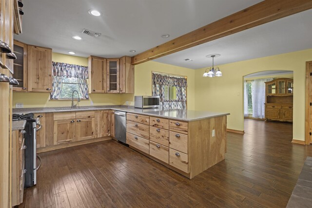 3042 Parish Cemetery Rd, Little Cypress, TX 77632 - kitchen with stainless steel appliances, a peninsula, arched walkways, dark wood finished floors, and glass insert cabinets