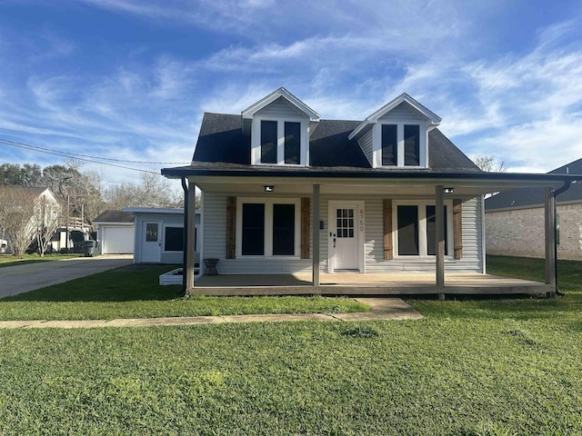 back of property featuring covered porch and a lawn