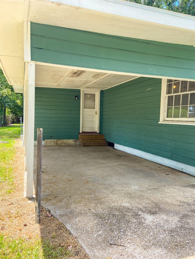 property entrance featuring a carport