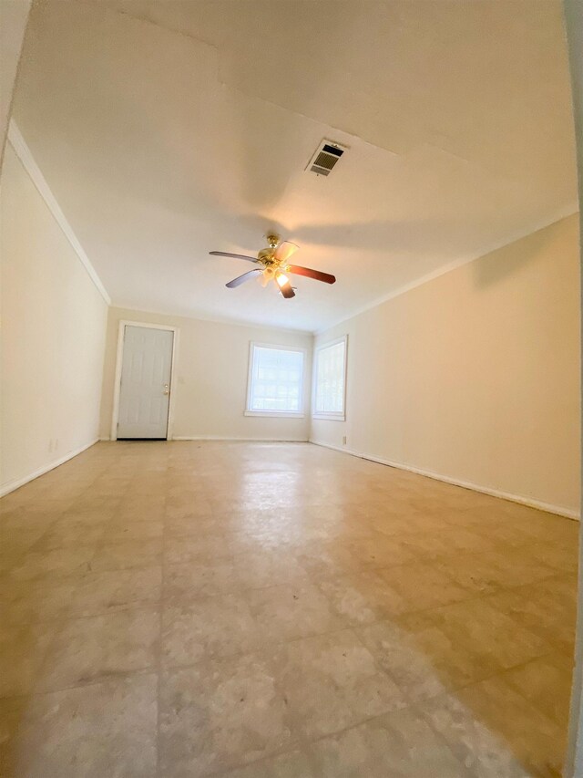 spare room with ceiling fan and crown molding