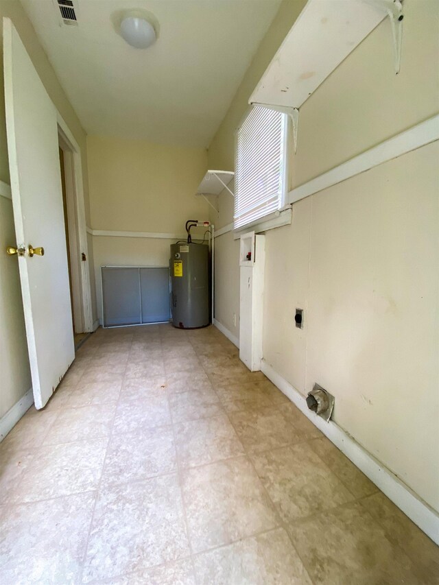 washroom with electric dryer hookup and water heater