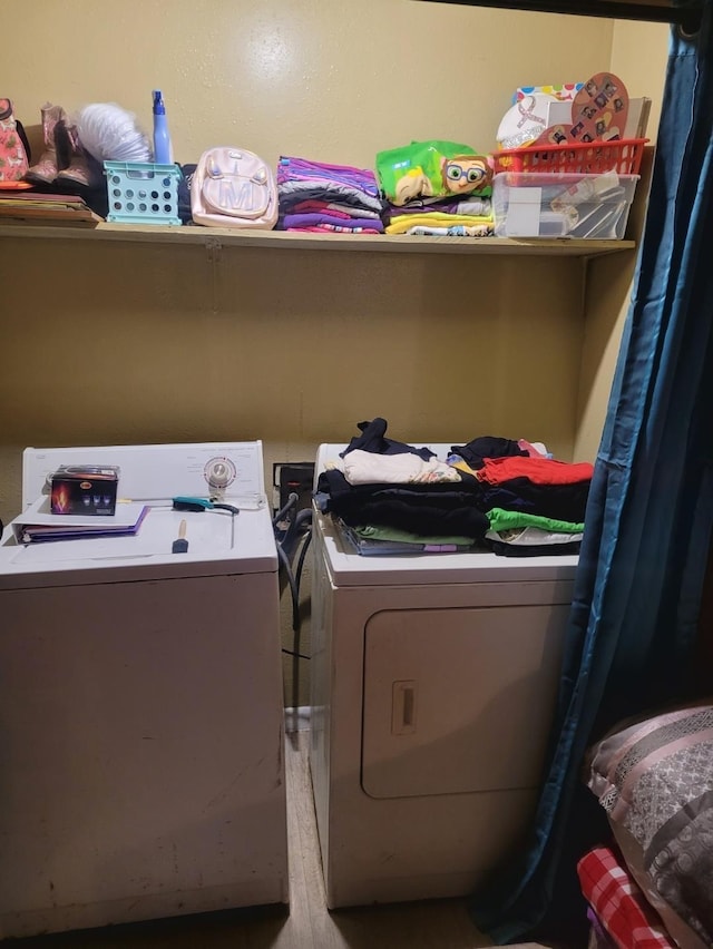 washroom featuring laundry area and separate washer and dryer