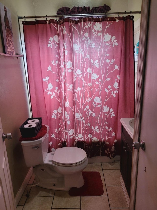 full bath with tile patterned flooring, baseboards, vanity, and toilet