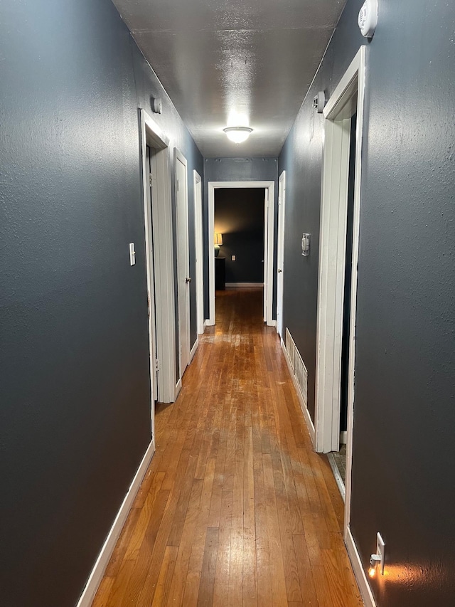 corridor featuring hardwood / wood-style floors