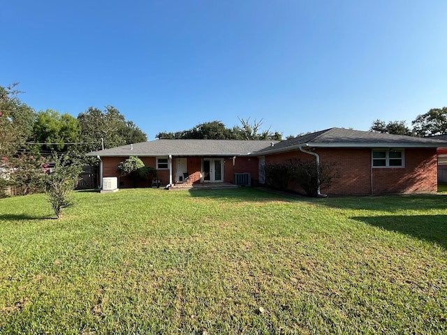 view of front of house featuring a front lawn and cooling unit