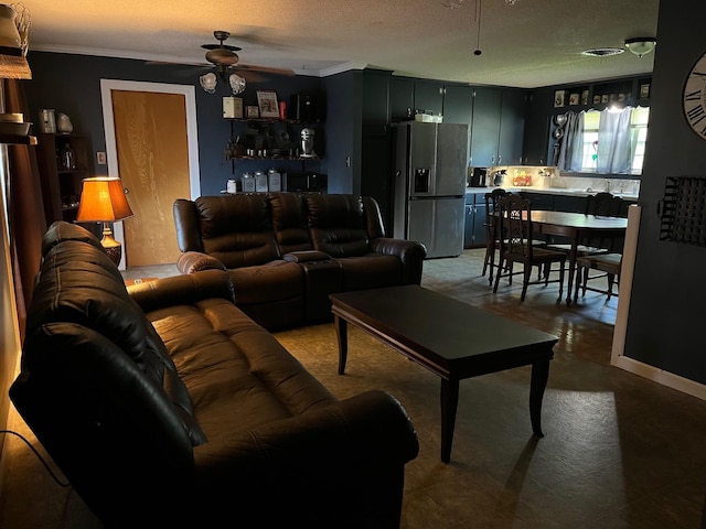 living room with ceiling fan, crown molding, and a textured ceiling