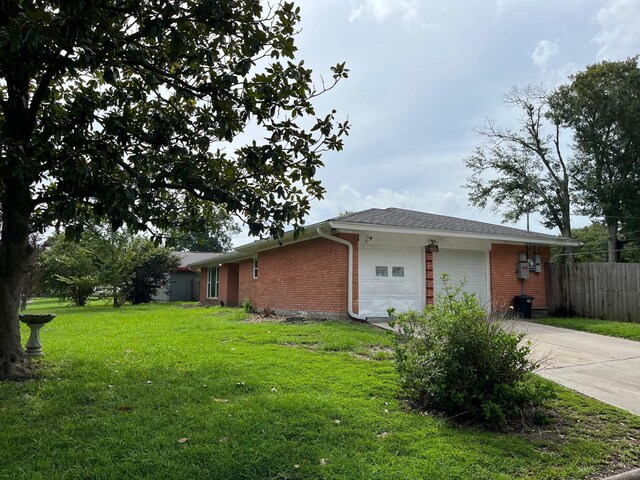 view of home's exterior featuring a lawn and a garage