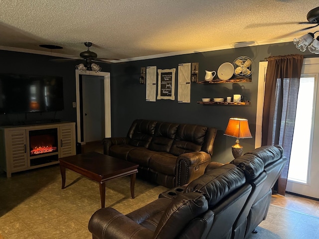 living room with ceiling fan, ornamental molding, a textured ceiling, and a wealth of natural light