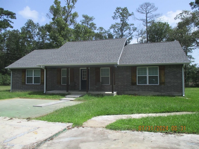 single story home with covered porch and a front lawn