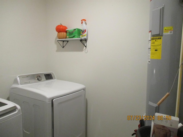 laundry area with washing machine and dryer and electric water heater