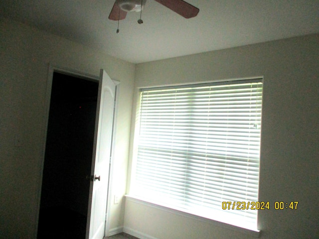 interior space featuring a walk in closet, ceiling fan, and a closet