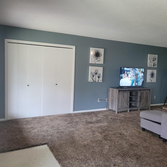 unfurnished room with carpet and a textured ceiling